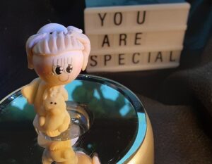 Clay figure with a sign saying "you are special" in the background