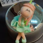 A clay figure sitting with the word "special" in the background