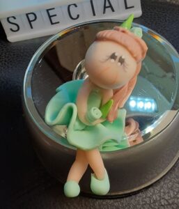 A clay figure sitting with the word "special" in the background