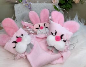 Three pink cloth rabbits with pearl eyes
