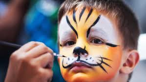 A bow having his face painted with yellow and black animal design.